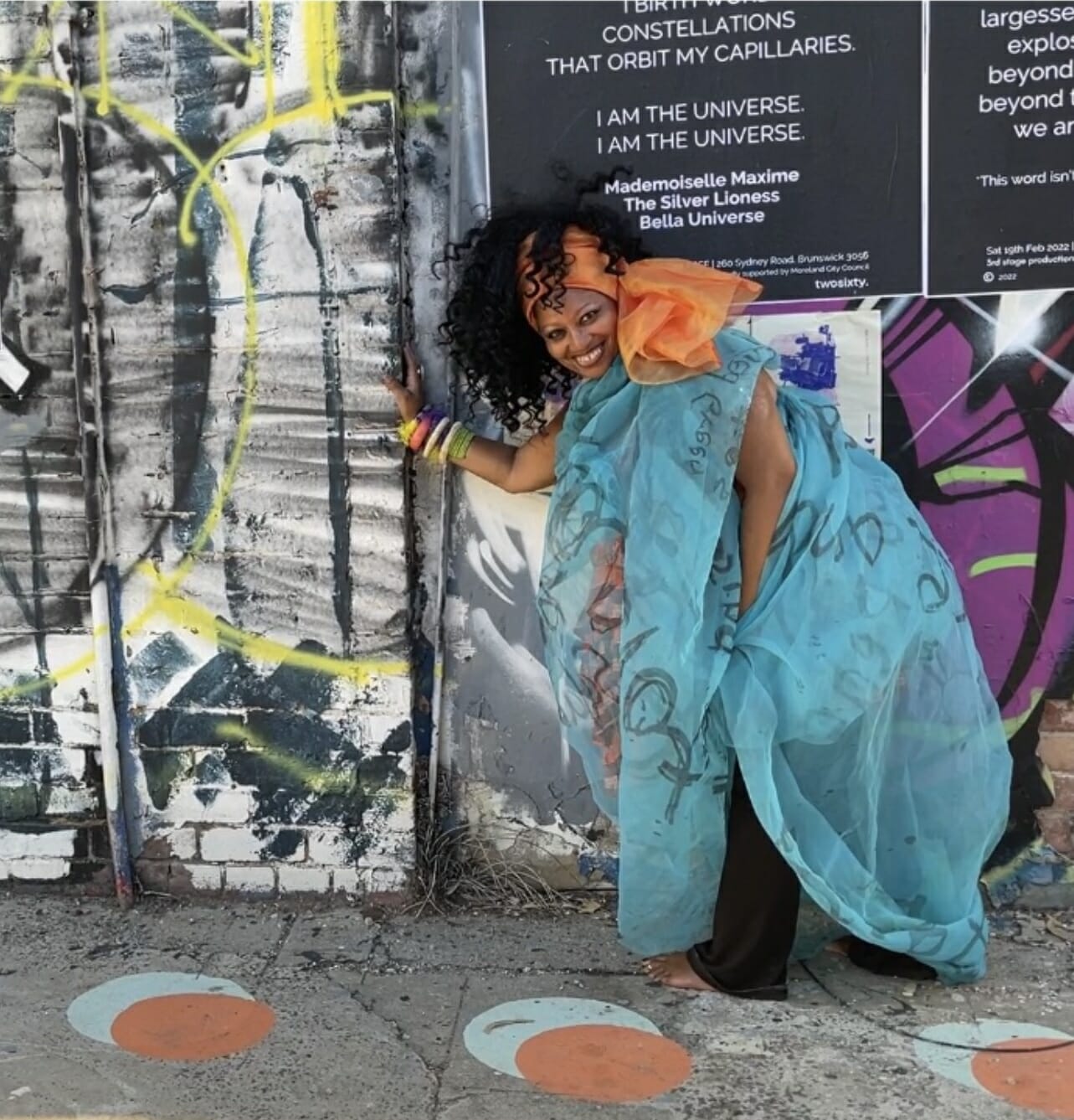 Maxime Banks posing outdoors in front of a wall