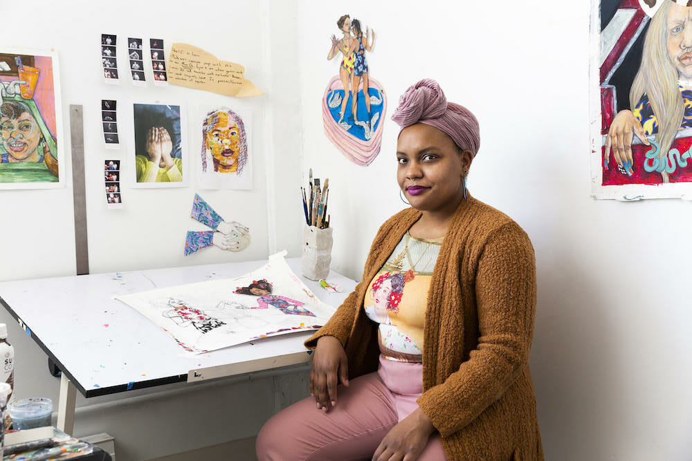 LaNia Sproles seated at a drawing desk