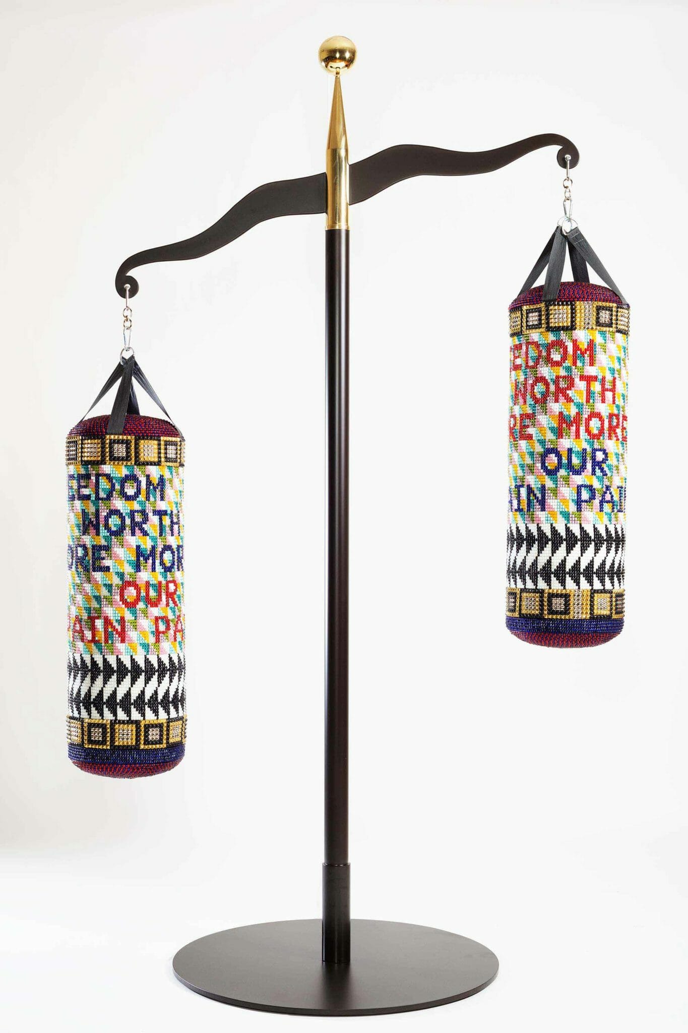 Jeffrey Gibson (Mississippi Band Choctaw/Cherokee), OUR FREEDOM IS WORTH MORE THAN OUR PAIN, 2017. Repurposed punching bags, glass beads, artificial sinew, acrylic felt, steel, and brass; 114 × 71 × 42 in. Collection of Vicki and Kent Logan. Image courtesy of Jeffrey Gibson Studio and Roberts Projects, Los Angeles, California. Photograph by Peter Mauney.