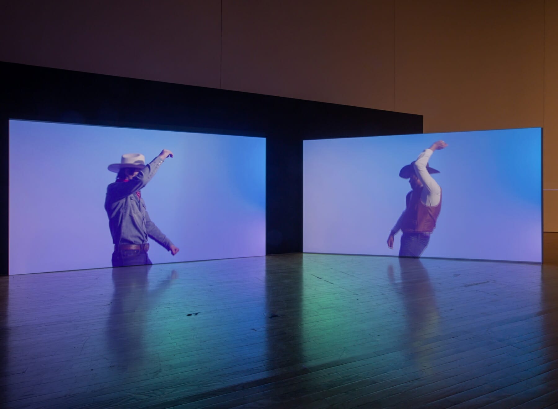 2 channel installation of Kenneth Tam: Silent Spikes with cowboys on screen