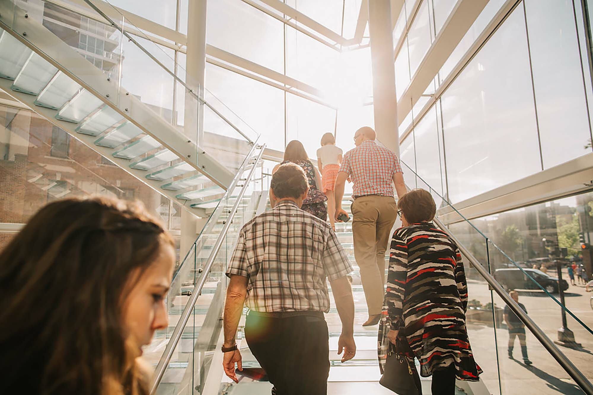 people walking up the Madison Museum of Contemporary Art's main staircase