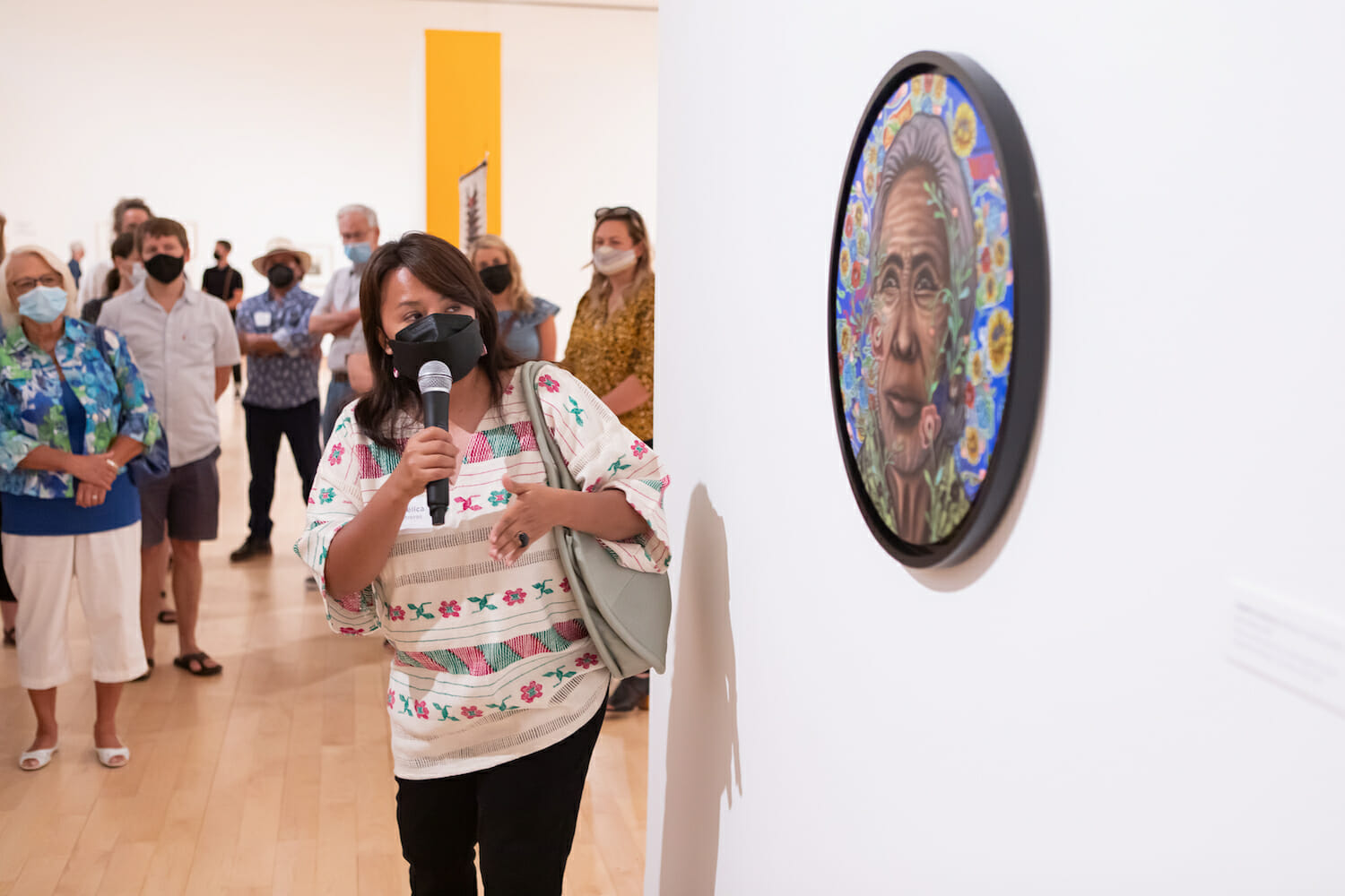 Angélica Contreras speaking into a microphone during her artist talk