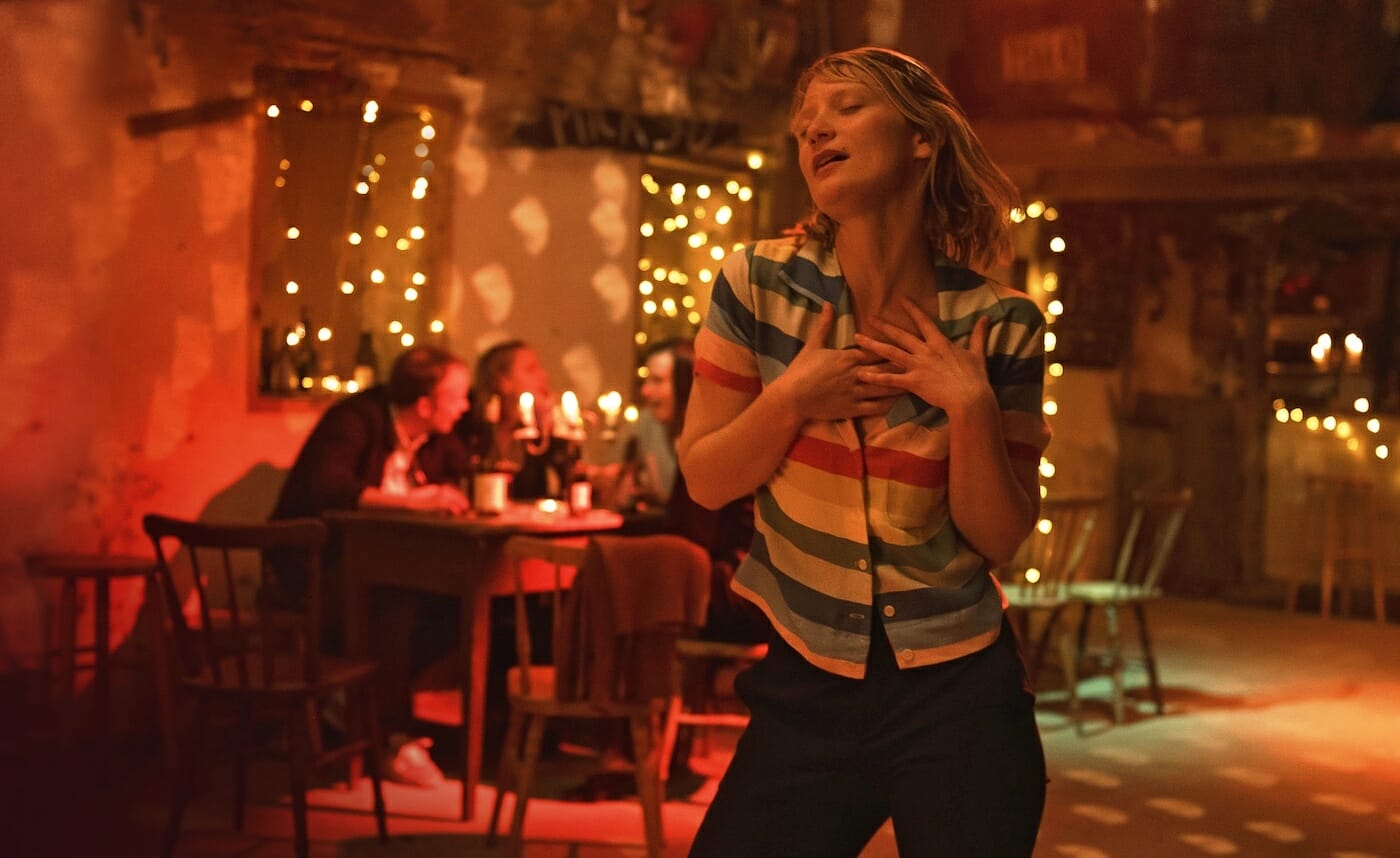 film still from showing a person dancing in a restaurant