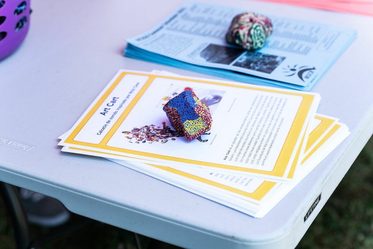 a rock paperweight on top of a stack of Art Cart project instructions