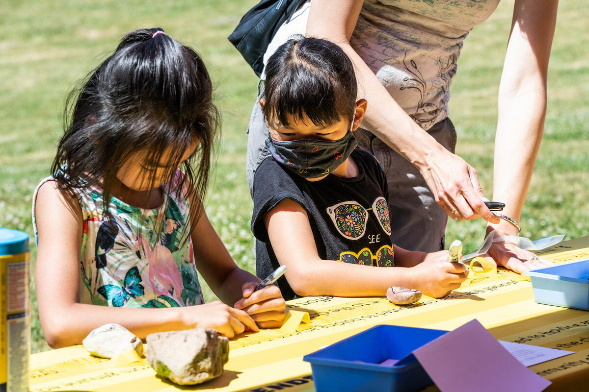 child looking at another child's writing