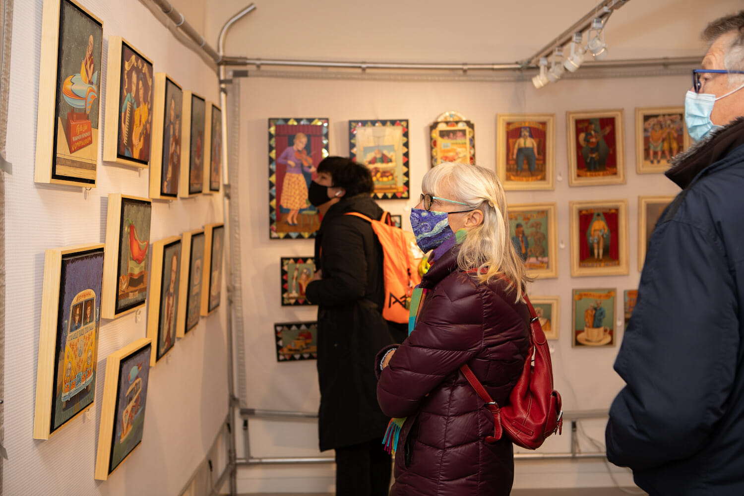 shopper looking at hanging artwork for sale