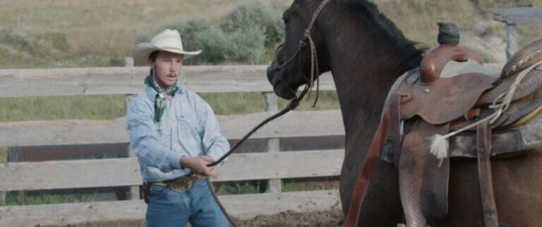 film still from The Rider (2017) showing a cowboy and a horse outdoors