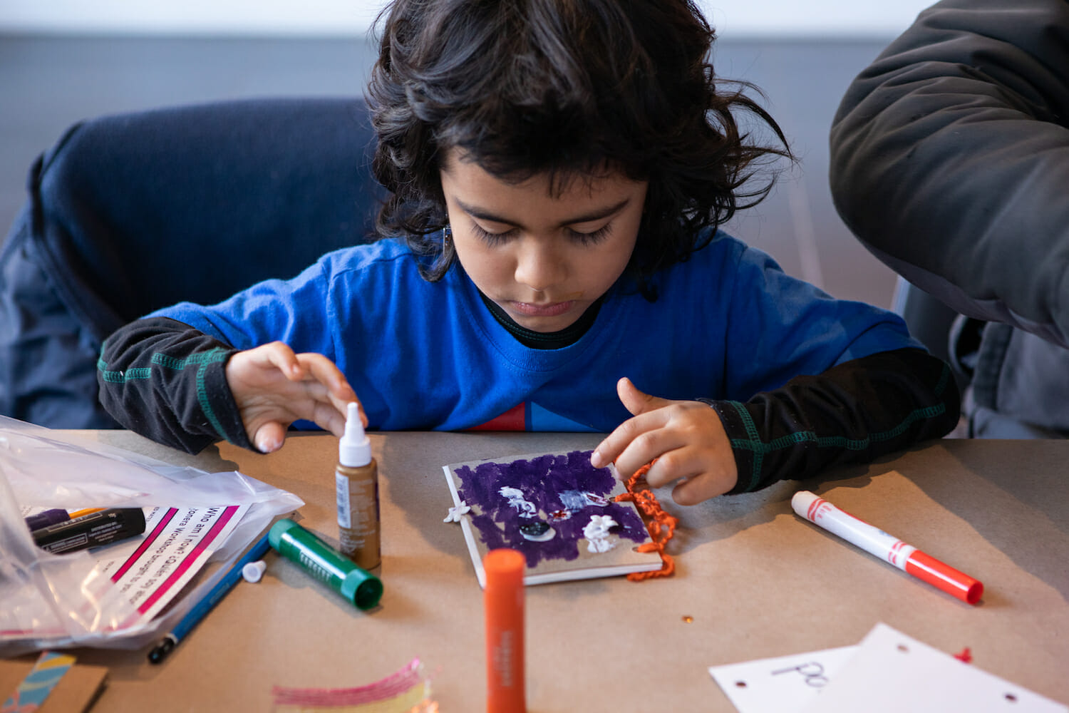 child decorating a book