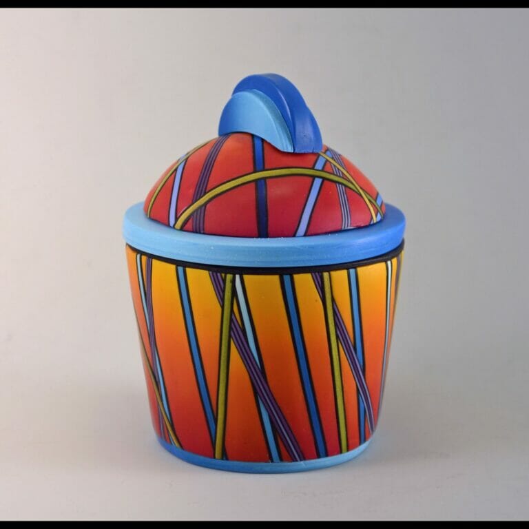 ceramic container or box with stem-like designs covering the container and lid, with a rounded semi-circle handle