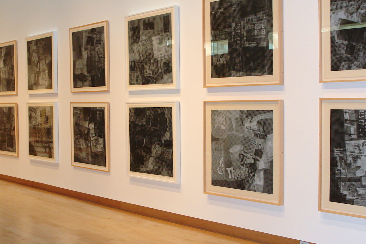 installation view of "Signs of the Times: Robert Rauschenberg's America" featuring artworks hanging on the wall