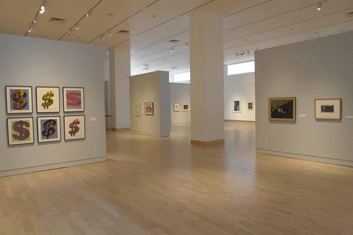 installation view of "Something Wicked This Way Comes" showing framed artworks hanging on the wall