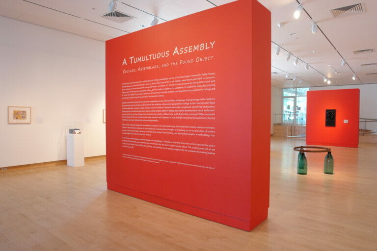 installation view of an exhibition with a wall with title text