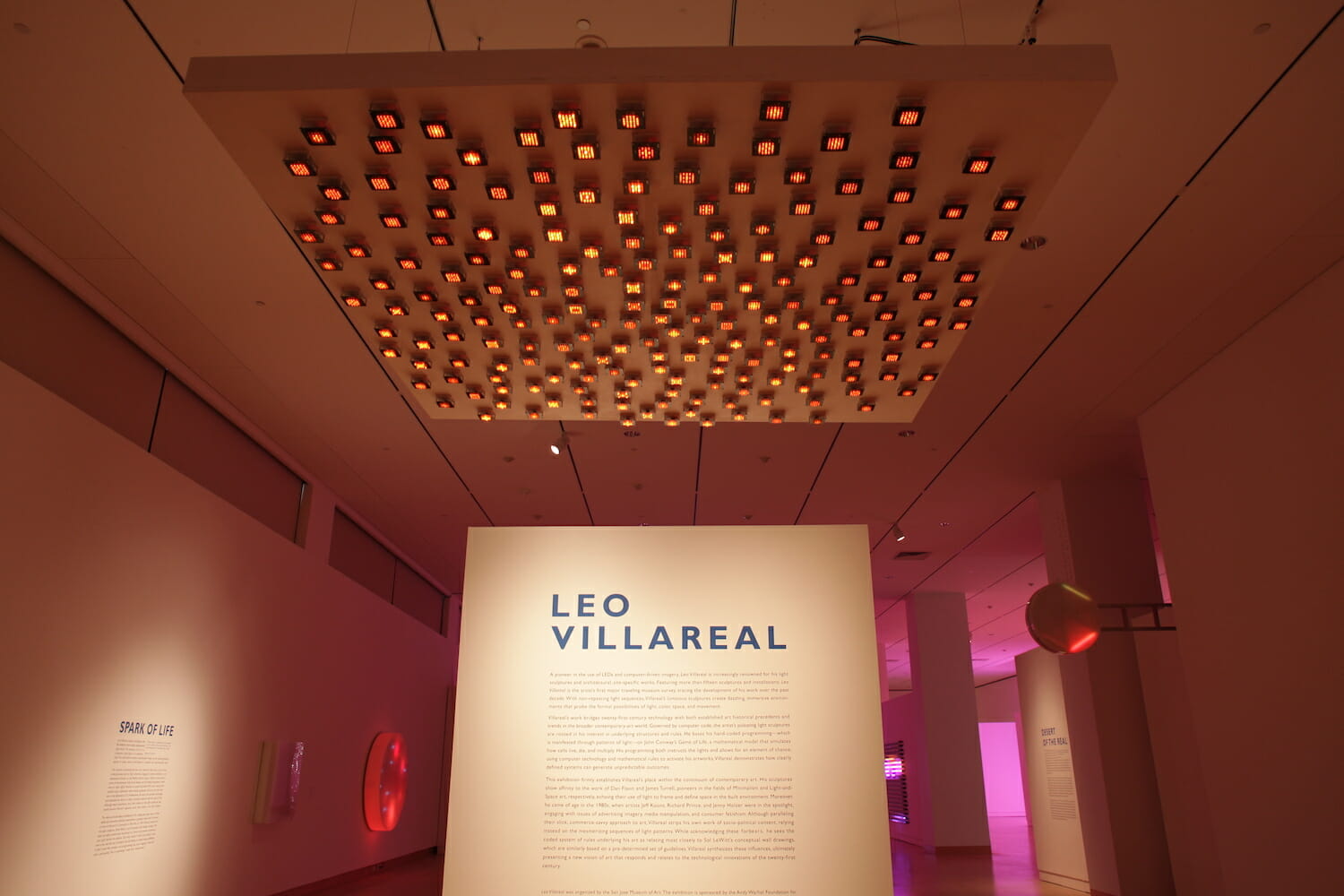 installation view of "Leo Villareal" showing title wall text and a light artwork hanging from the ceiling