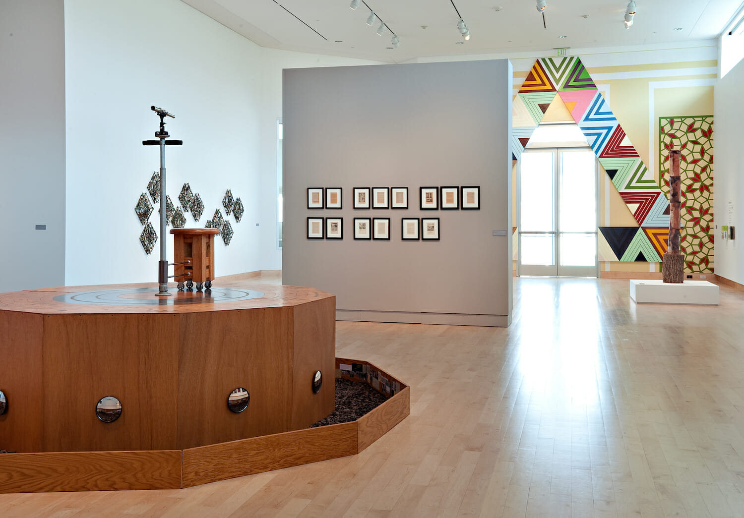 installation view of the 2010 Wisconsin Triennial featuring a large sculpture and framed artworks