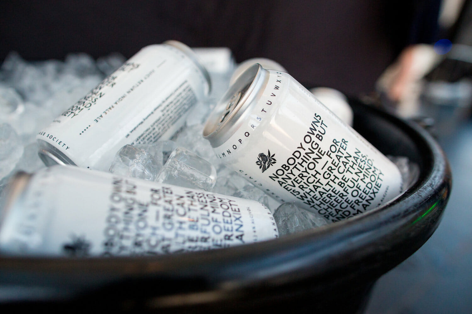 a bowl full of beer cans chilling in ice