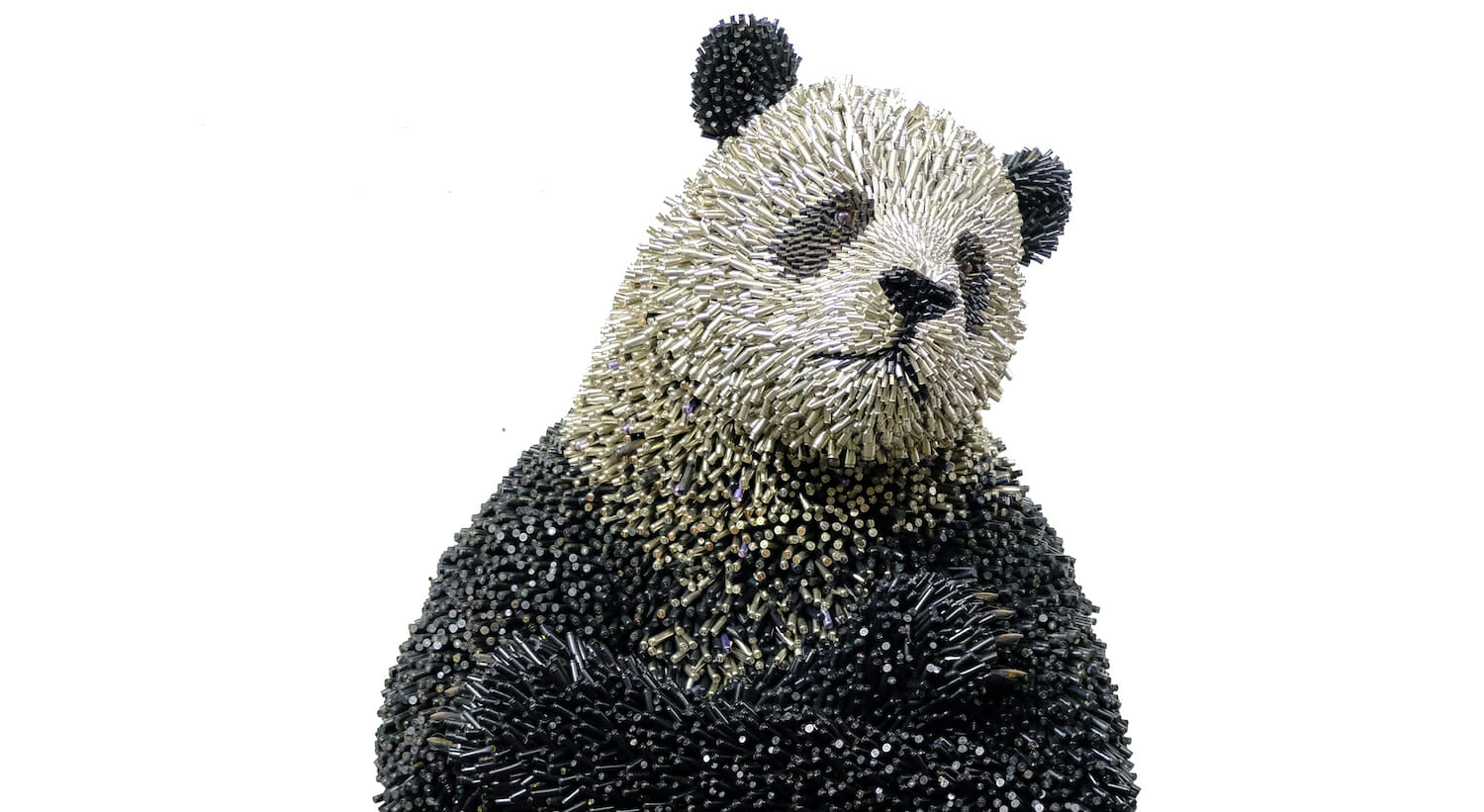 Panda bear sculpture made of bullet shells.