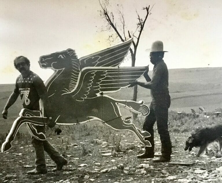 Tandem Press founder Bill Weege, left, and Sam Gilliam, in rural Wisconsin. They both hold up a large artwork of a pegasus.