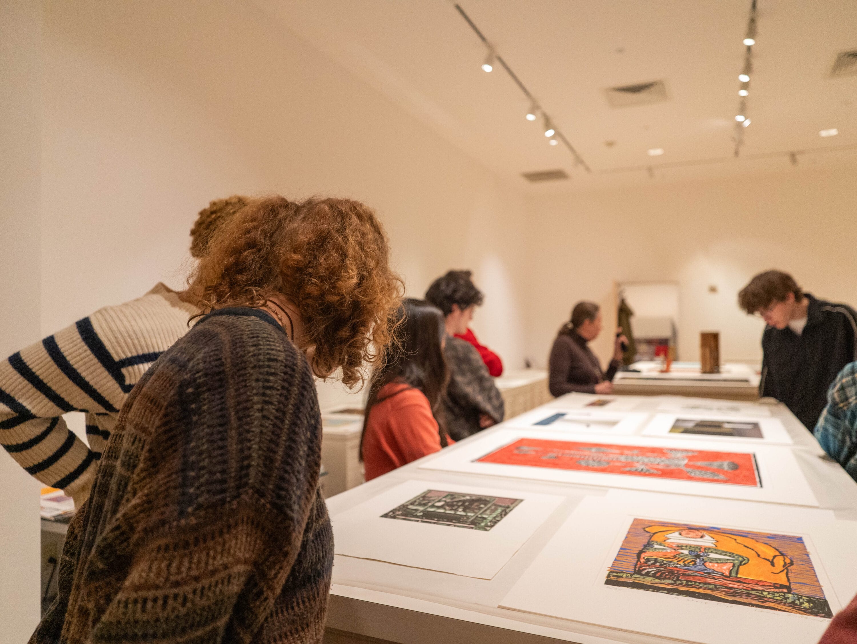 2024 Teen Forum members looking at artworks in the Museum's Works on Paper collection.